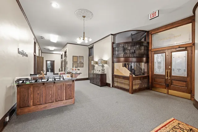 a living room with furniture and a chandelier