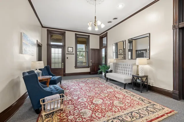 a living room with furniture and a chandelier