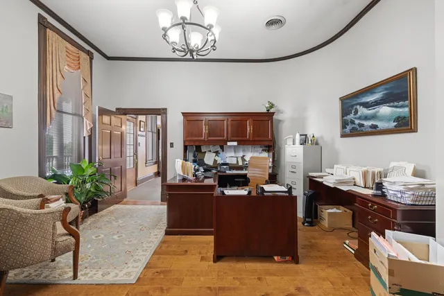 a work place with furniture and wooden floor