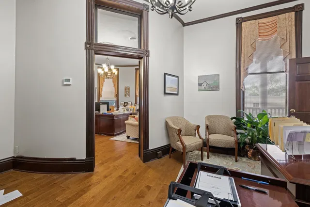a living room with fireplace furniture and a chandelier