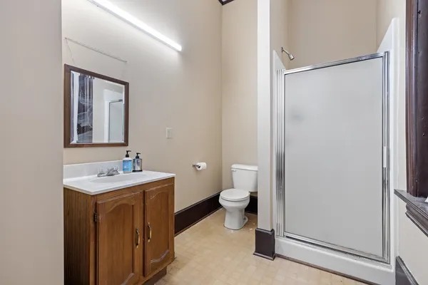 an empty room with closet and windows