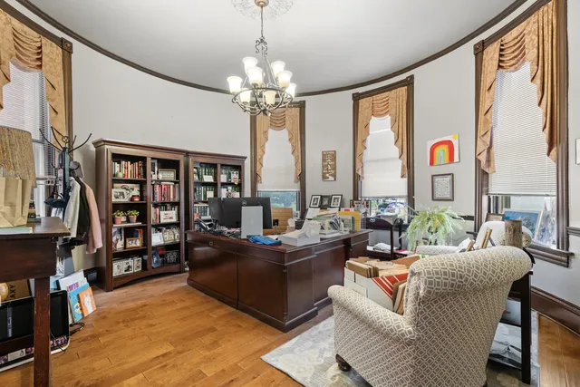 a view of a hallway with furniture and a window