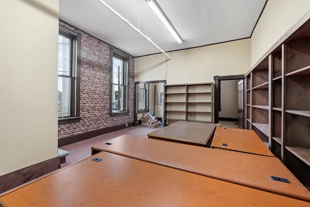 a room with pool table and windows