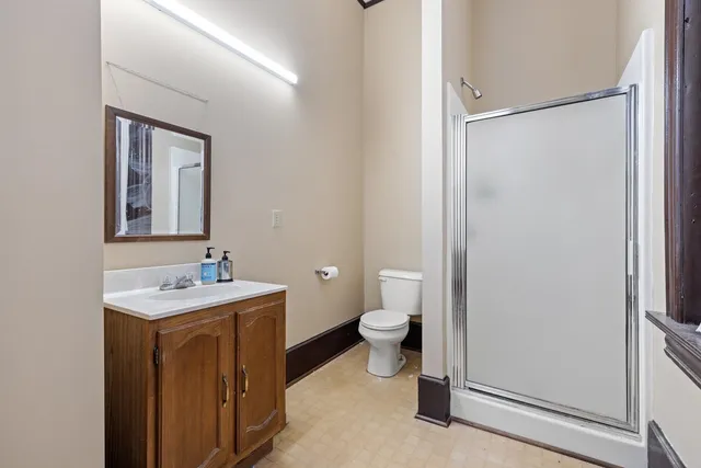 an empty room with closet and windows