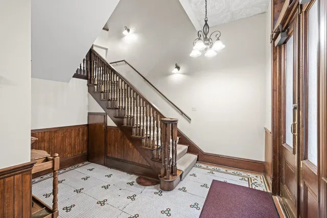a view of a hallway with wooden floor and windows