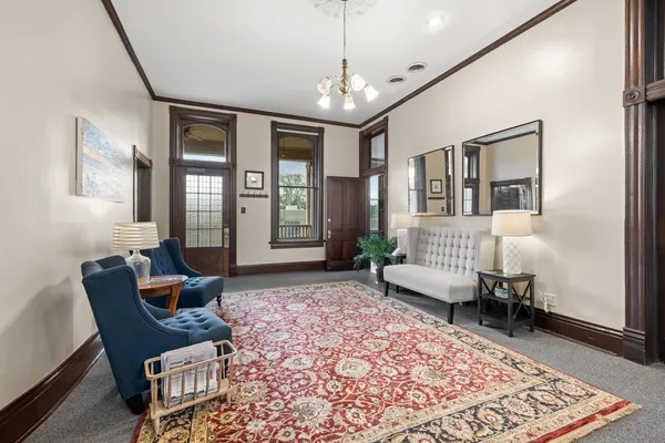 a living room with furniture and a chandelier