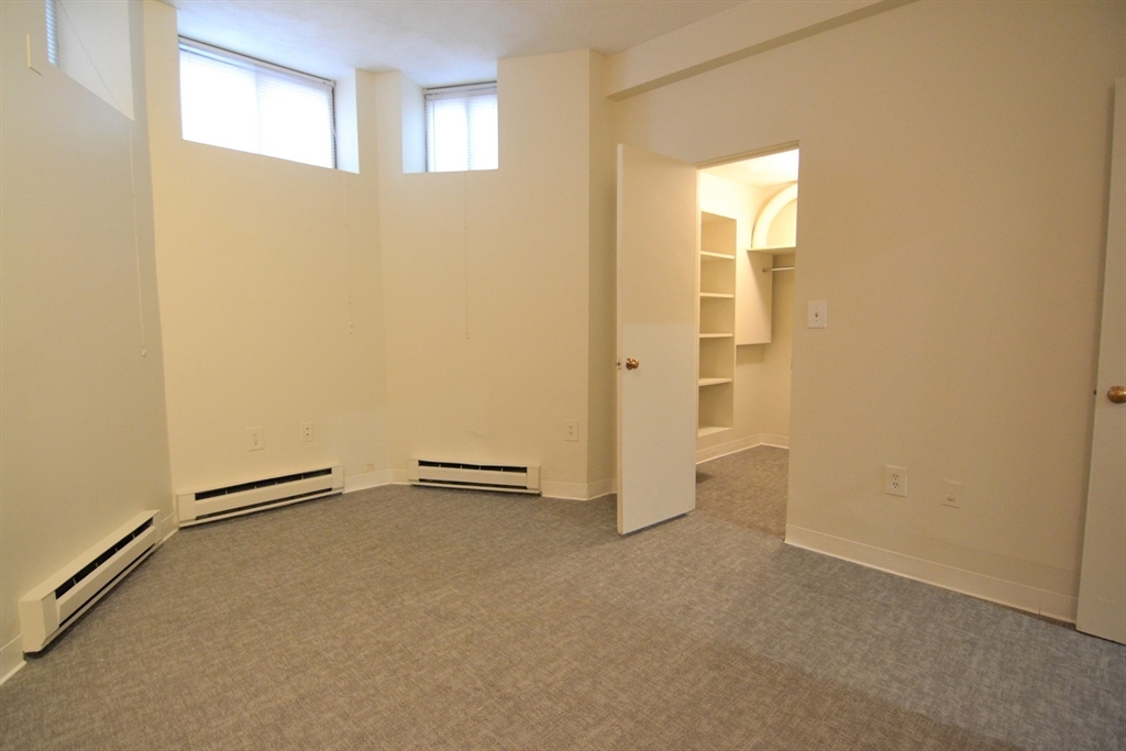 67 St Germain Street, Unit 191 Boston, MA 02115 - Photo 9 of 13 an empty room with a windows and closet