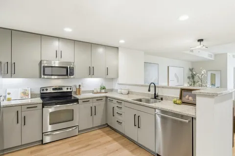 a kitchen with a sink stove and microwave