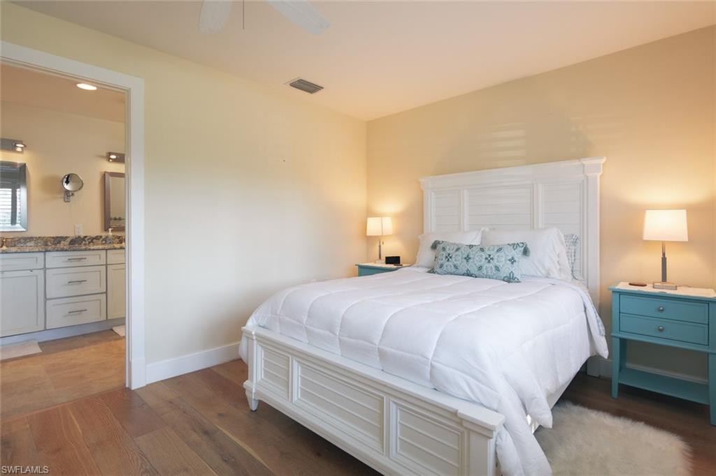 2155 Tarpon Road Naples, FL 34102 - Photo 16 of 27 a bedroom with a bed and a cabinets