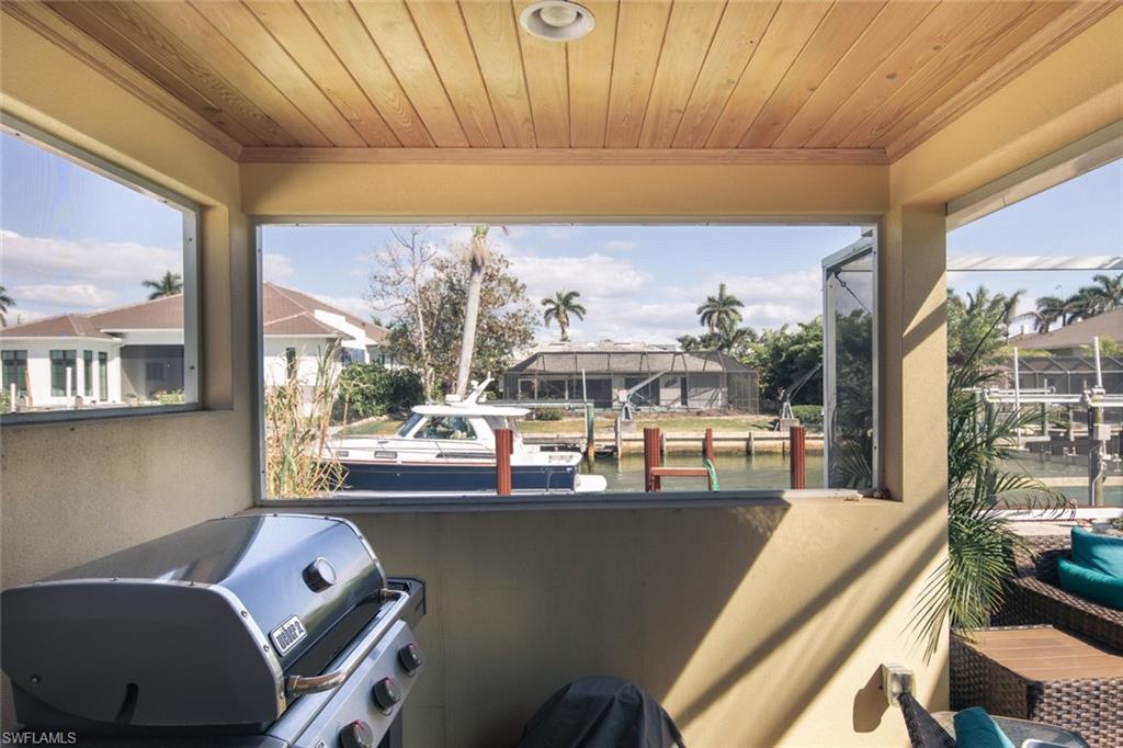 2155 Tarpon Road Naples, FL 34102 - Photo 19 of 27 a dining room with furniture and a window