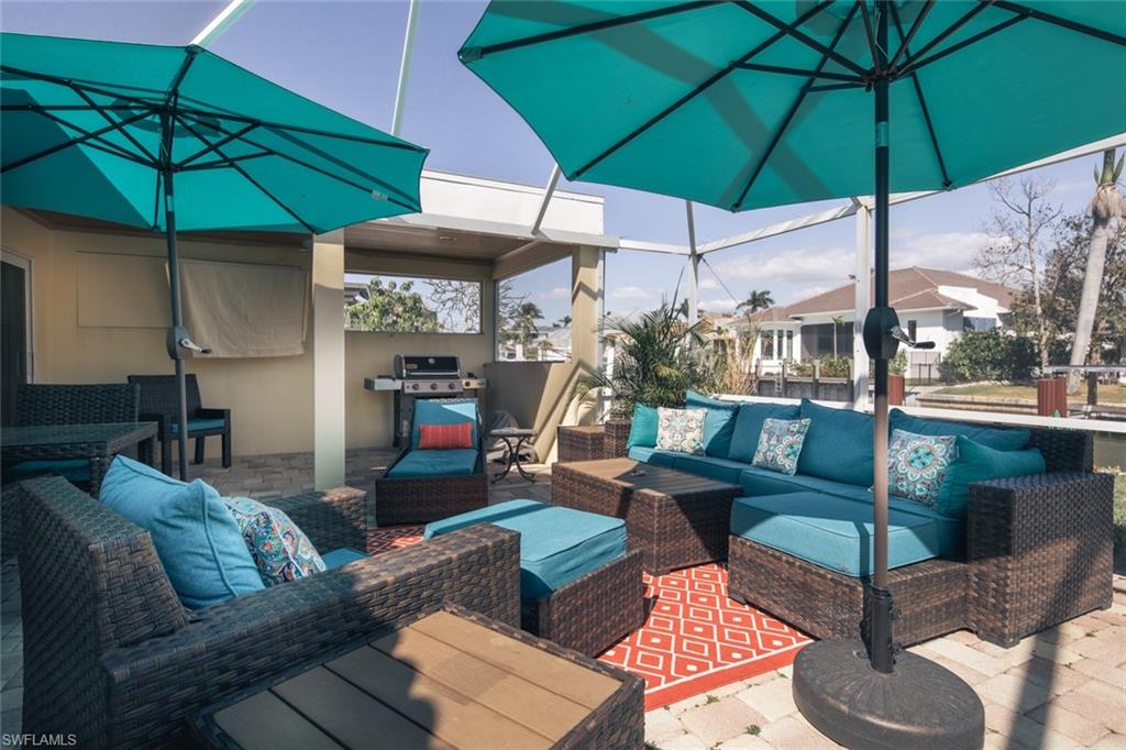 2155 Tarpon Road Naples, FL 34102 - Photo 20 of 27 a view of a patio with couches under an umbrella