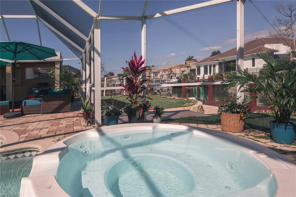 2155 Tarpon Road Naples, FL 34102 - Photo 7 of 27 a view of a swimming pool with an outdoor seating
