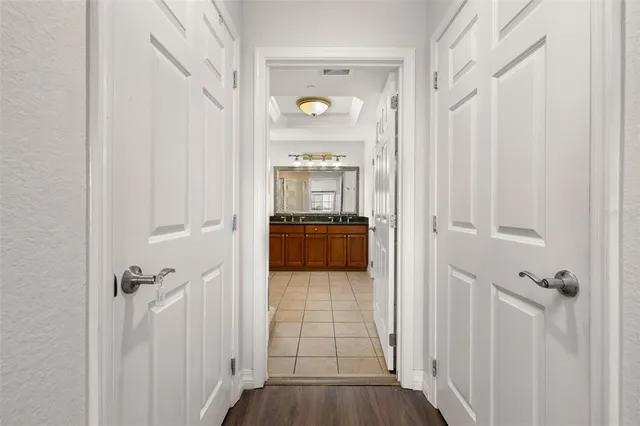 a view of a porch with a floor to ceiling window and potted plants