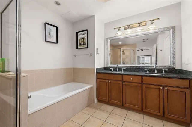 a view of a big yard with plants and a large tree