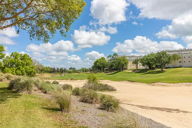 a front view of a multi story residential apartment building with a yard