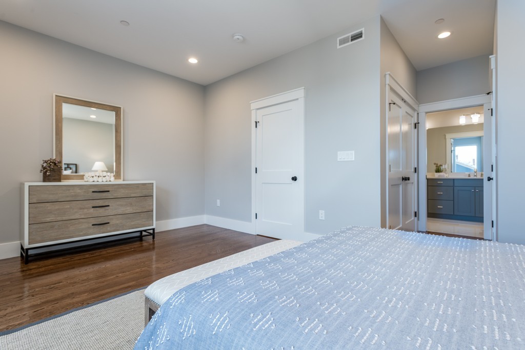 227 Cedar Street, Unit 6 Somerville, MA 02145 - Photo 15 of 25 a bedroom with a bed and a mirror