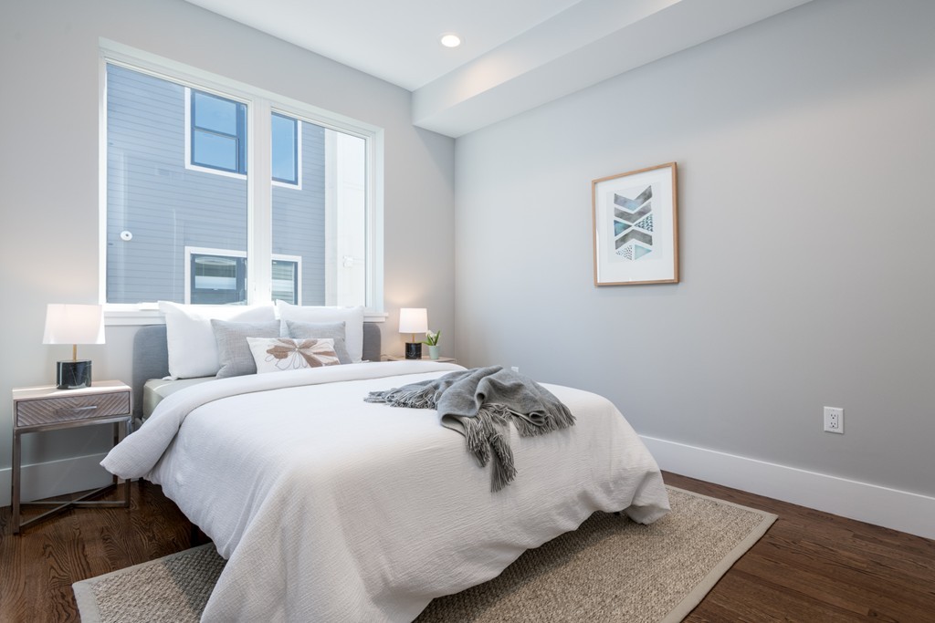 227 Cedar Street, Unit 6 Somerville, MA 02145 - Photo 16 of 25 a bedroom with bed and wooden floor