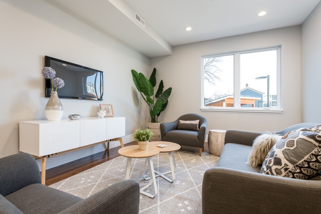 227 Cedar Street, Unit 6 Somerville, MA 02145 - Photo 2 of 25 a living room with furniture and a large window