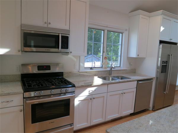 9 Blueberry Road Marblehead, MA 01945 - Photo 5 of 13 a kitchen with stainless steel appliances granite countertop white cabinets granite counter tops and a window