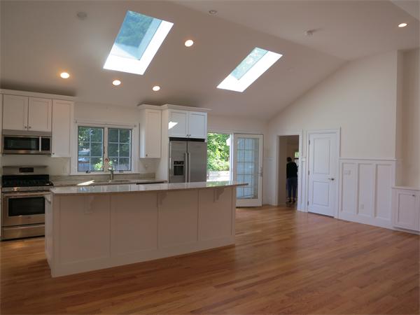 9 Blueberry Road Marblehead, MA 01945 - Photo 6 of 13 a large kitchen with stainless steel appliances granite countertop a stove a sink dishwasher and a refrigerator with wooden floor
