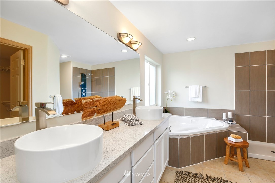 4408 Northeast 3rd Lane Renton, WA 98059 - Photo 14 of 25 a spacious bathroom with a double vanity sink and a mirror