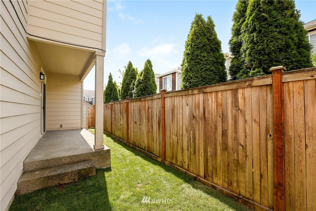 4408 Northeast 3rd Lane Renton, WA 98059 - Photo 24 of 25 a view of a backyard with wooden fence and large trees