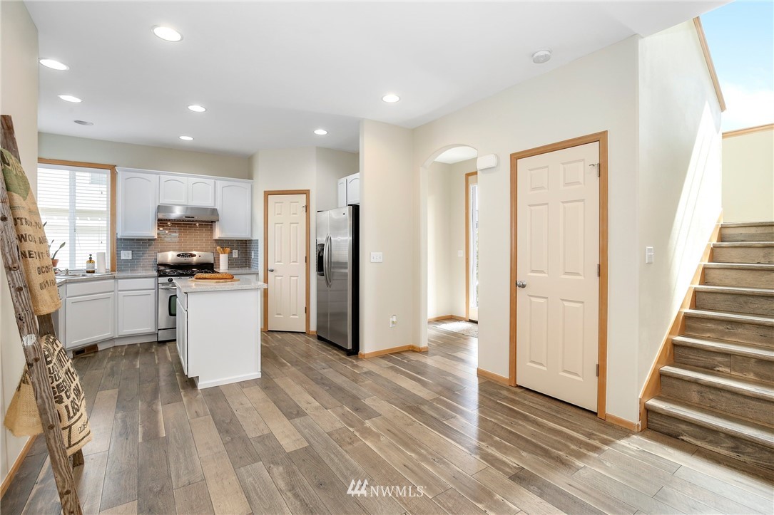 4408 Northeast 3rd Lane Renton, WA 98059 - Photo 8 of 25 a kitchen with white cabinets and stainless steel appliances