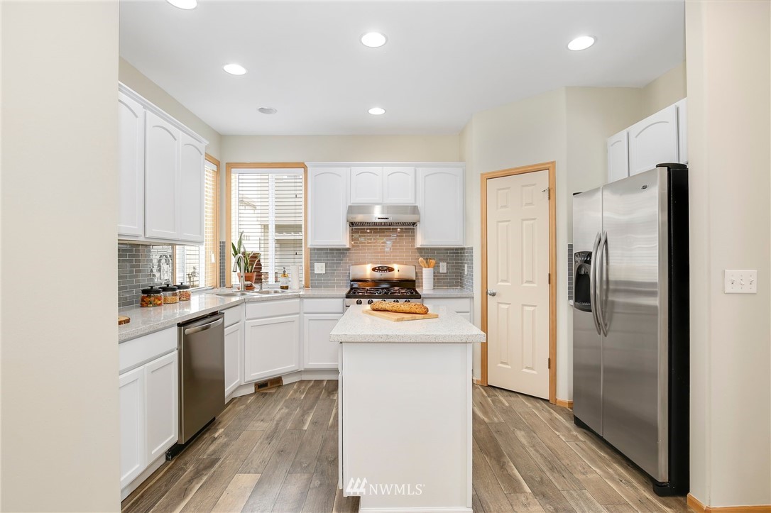 4408 Northeast 3rd Lane Renton, WA 98059 - Photo 9 of 25 a kitchen with a refrigerator a sink and a stove