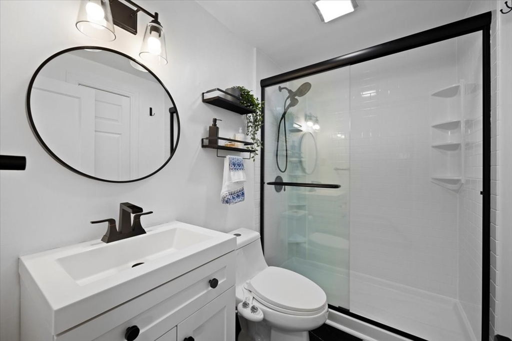 4 Webster Street Randolph, MA 02368 - Photo 14 of 32 a bathroom with a sink a toilet and a mirror