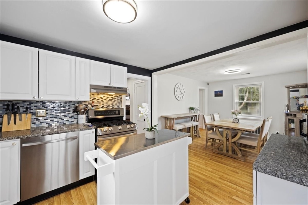 4 Webster Street Randolph, MA 02368 - Photo 18 of 32 a kitchen with stainless steel appliances kitchen island granite countertop a sink and cabinets
