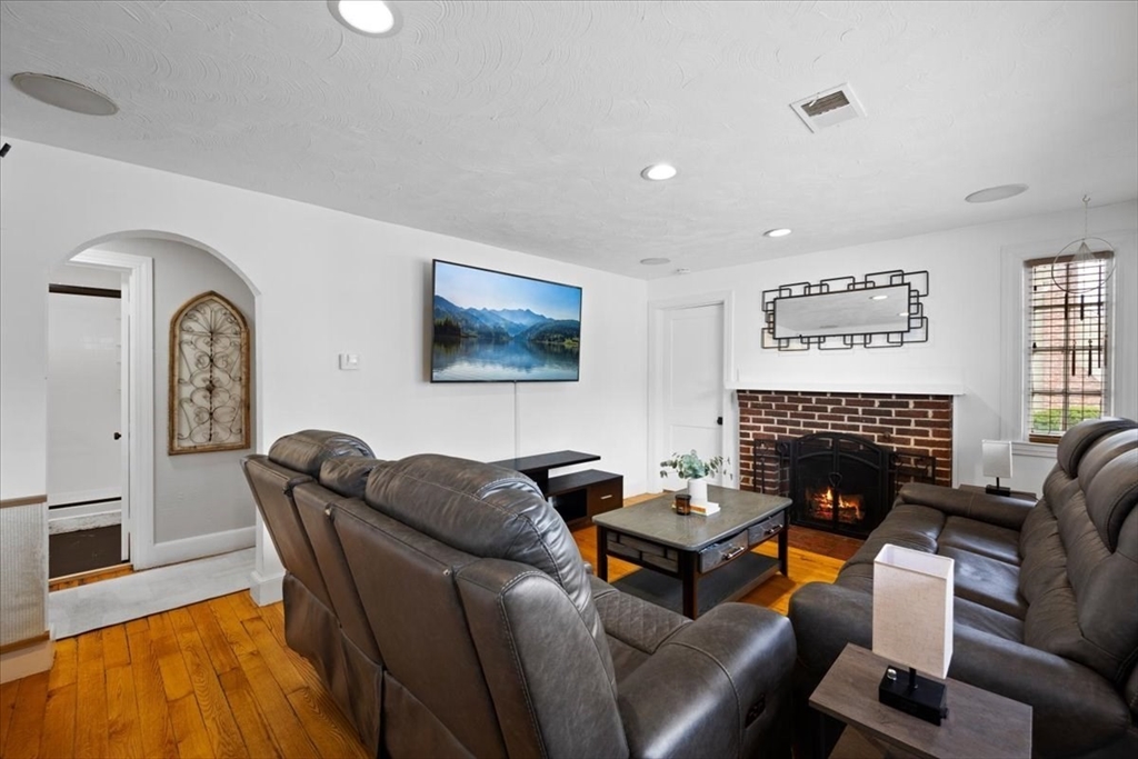 4 Webster Street Randolph, MA 02368 - Photo 4 of 32 a living room with furniture a fireplace and a flat screen tv