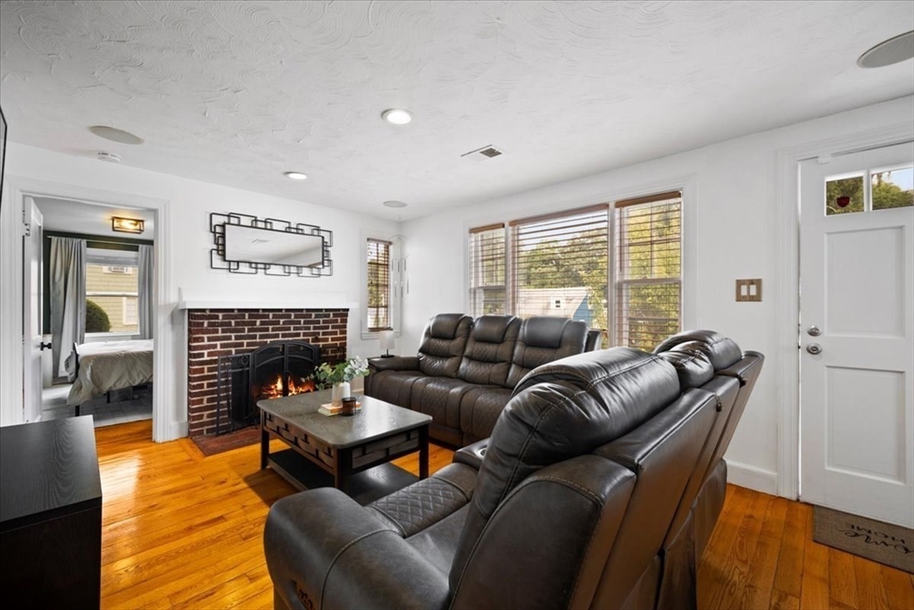 4 Webster Street Randolph, MA 02368 - Photo 7 of 32 a living room with furniture and a fireplace
