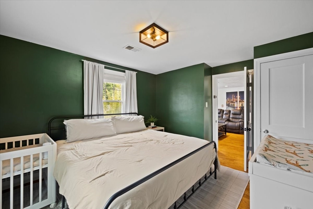 4 Webster Street Randolph, MA 02368 - Photo 10 of 32 a bedroom with a bed and a window