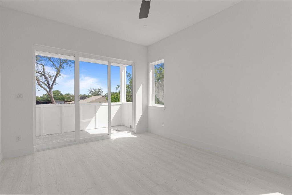 1847 Pollard Street Dallas, TX 75208 - Photo 4 of 11 Empty room with light wood finished floors and a ceiling fan
