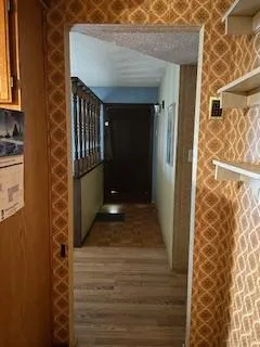 an empty room with wooden floor and closet