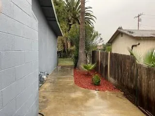 a view of a house with a small yard and potted plants
