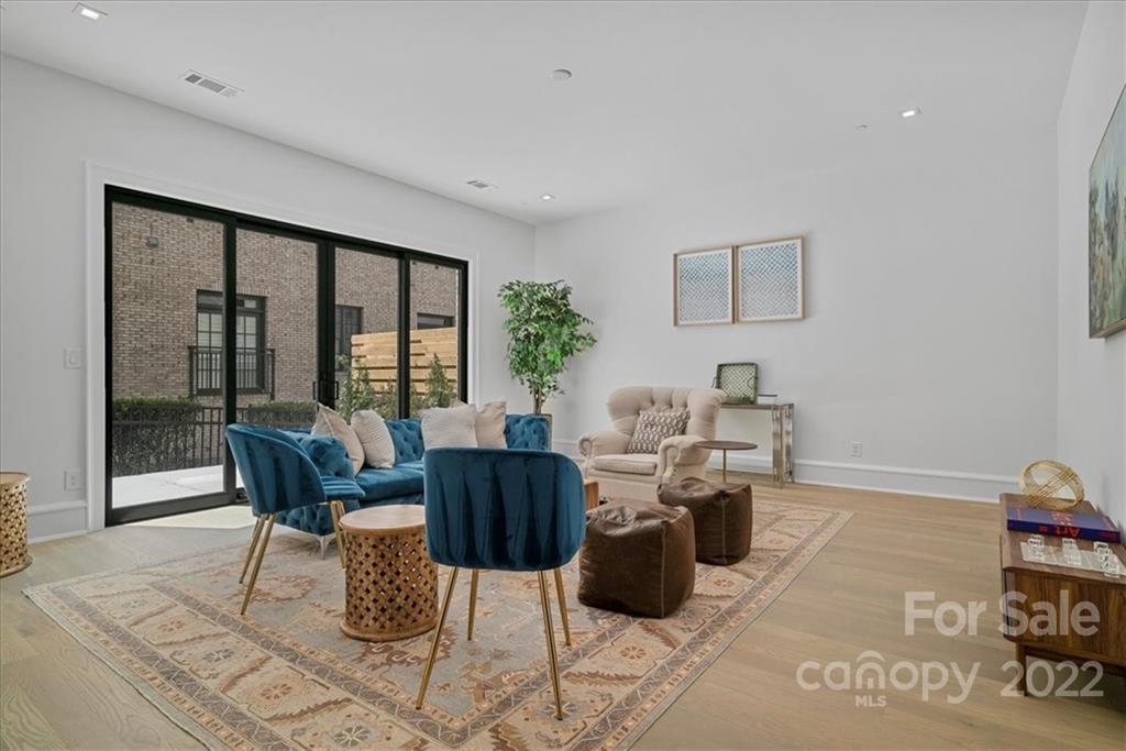 616 Queens Road Charlotte, NC 28204 - Photo 19 of 38 a living room with furniture a rug and a large window