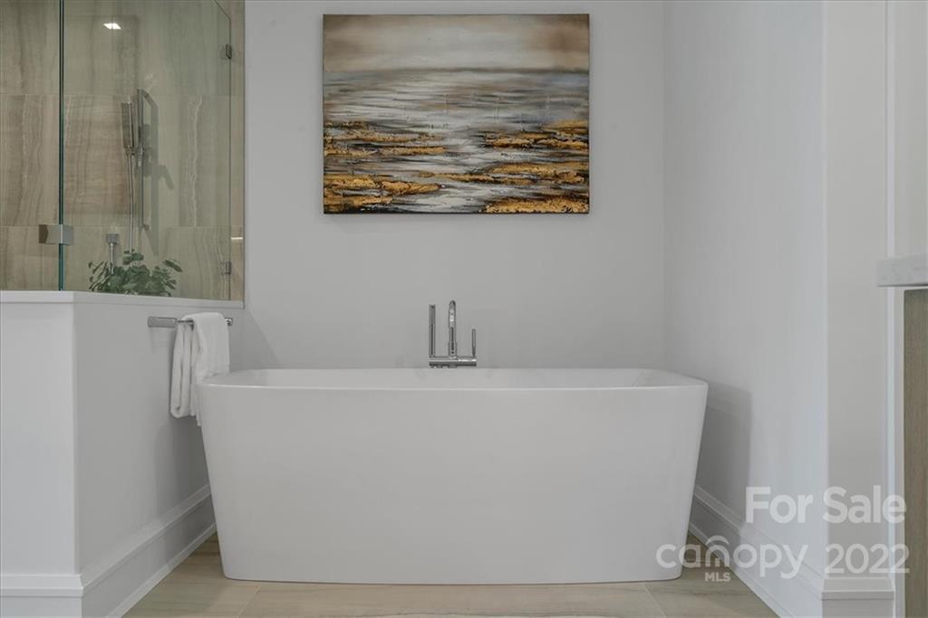 616 Queens Road Charlotte, NC 28204 - Photo 26 of 38 a white bath tub sitting in a bathroom