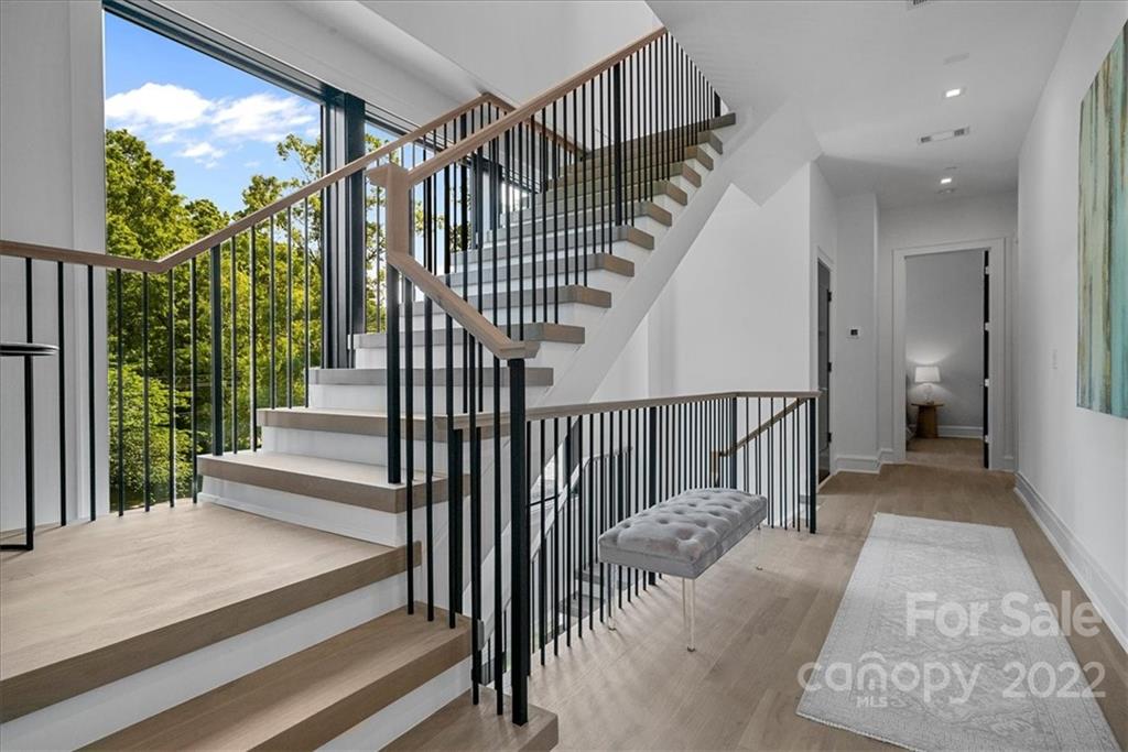 616 Queens Road Charlotte, NC 28204 - Photo 30 of 38 a view of staircase with lots of frames on wall and a large window