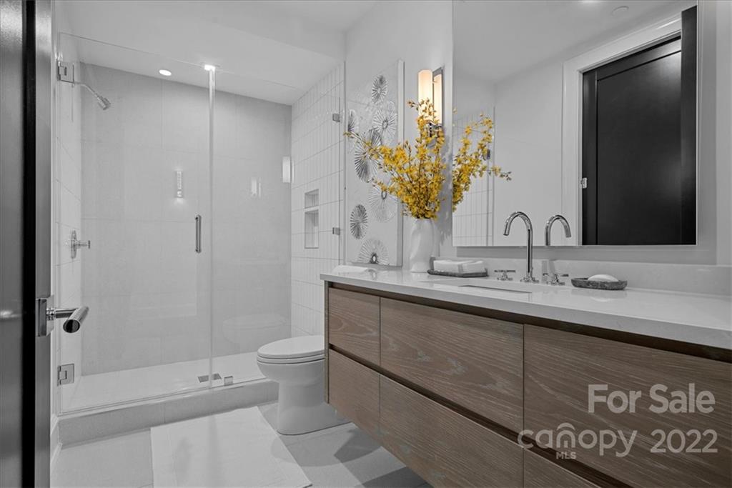 616 Queens Road Charlotte, NC 28204 - Photo 32 of 38 a bathroom with a sink a toilet and shower