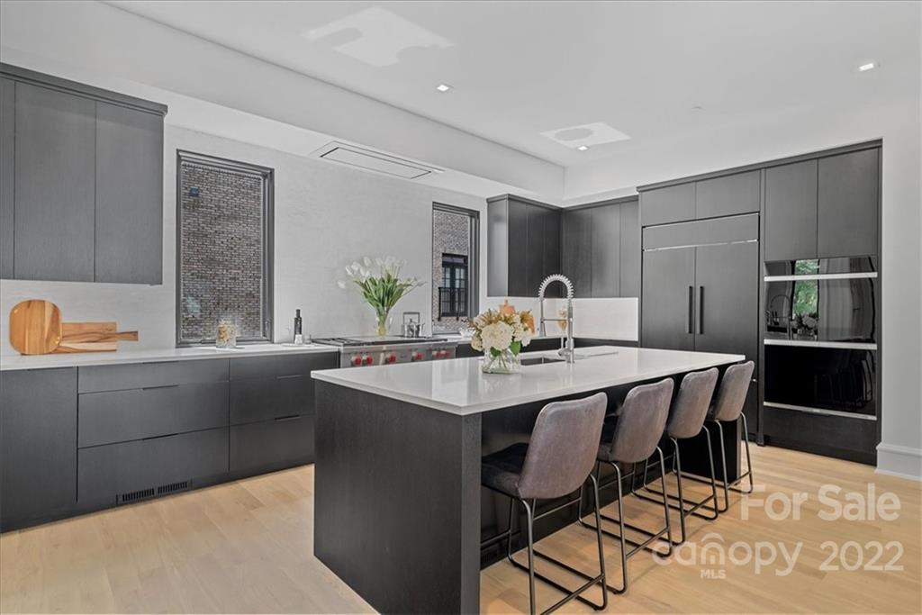 616 Queens Road Charlotte, NC 28204 - Photo 7 of 38 a kitchen with a table chairs in it and wooden floors