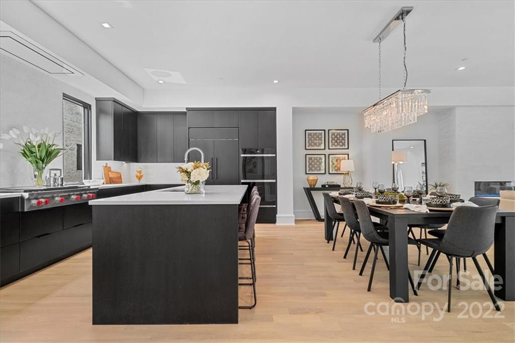 616 Queens Road Charlotte, NC 28204 - Photo 8 of 38 a dining hall with stainless steel appliances kitchen island granite countertop a dining table chairs and granite counter tops