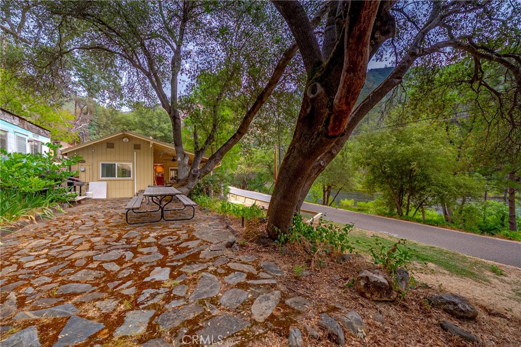 9977 Incline Road El Portal, CA 95318 - Photo 16 of 46 a white house that has a tree in front of it