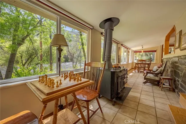 a dining room with furniture a chandelier and wooden floor