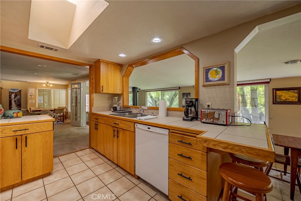 9977 Incline Road El Portal, CA 95318 - Photo 22 of 46 a kitchen with stainless steel appliances granite countertop a sink and cabinets
