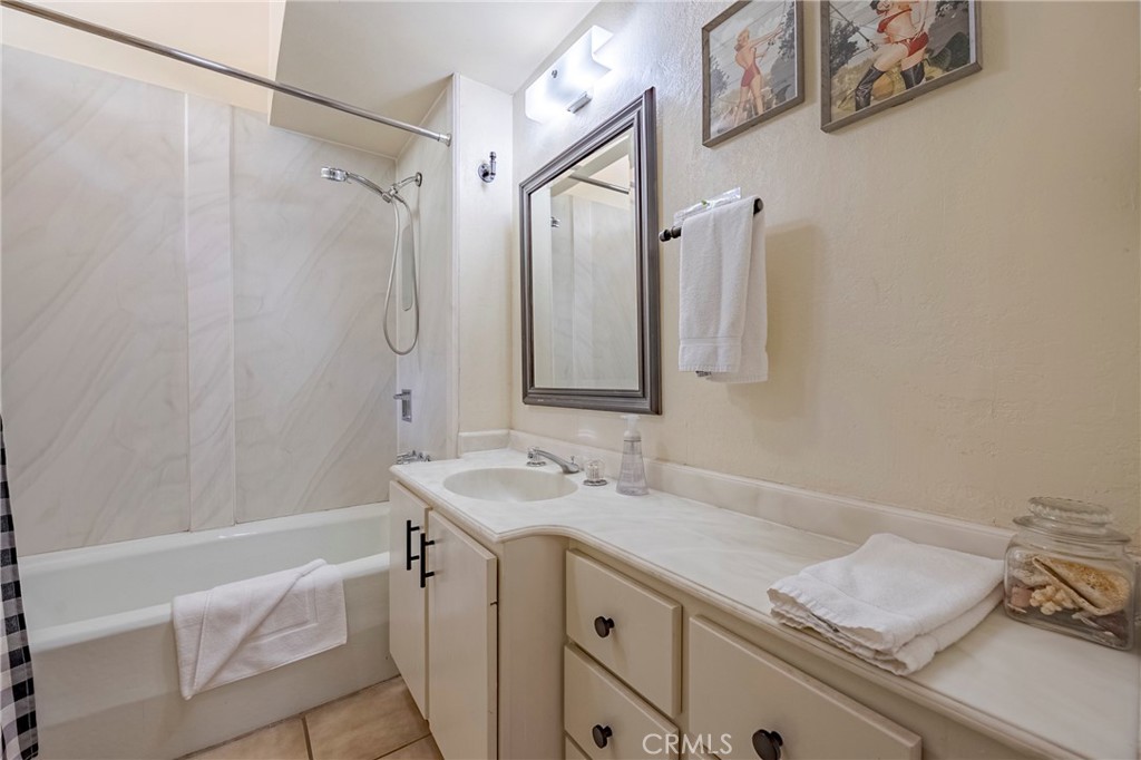 9977 Incline Road El Portal, CA 95318 - Photo 31 of 46 a bathroom with a granite countertop sink a mirror and a shower