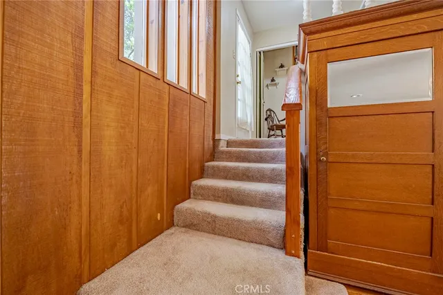 a bedroom with a bed and painting on the wall