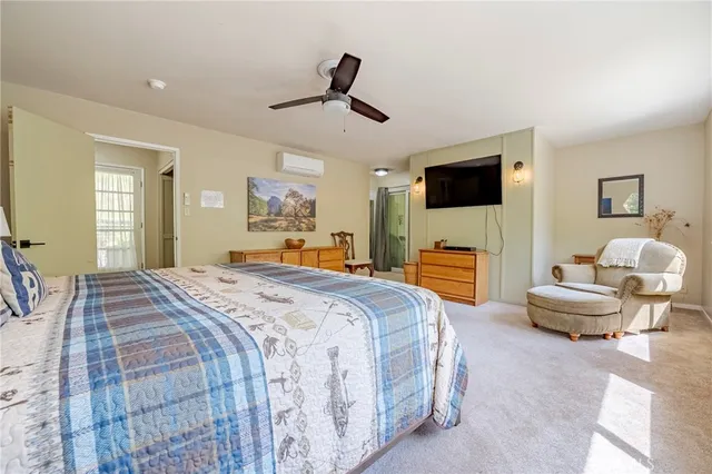 a bedroom with a large window and a bed