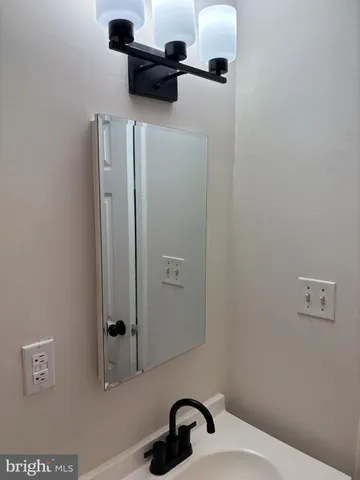 a bathroom with a sink and mirror