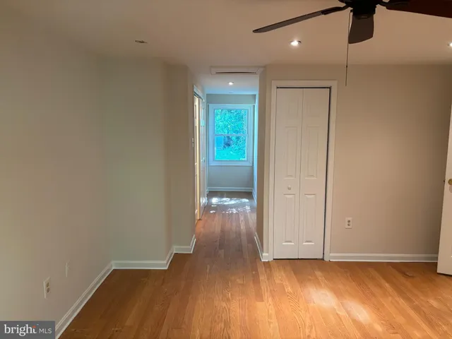 a view of hallway with wooden floor